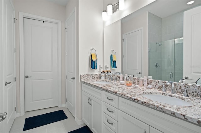 bathroom featuring vanity, tile patterned floors, and a shower with shower door