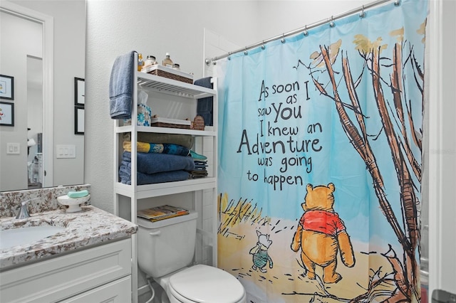 bathroom with vanity, a shower with shower curtain, and toilet