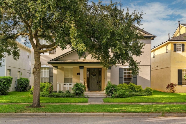 view of front of house with a porch and a front lawn