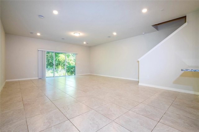 spare room featuring light tile patterned floors