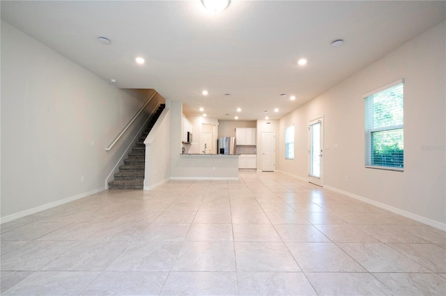 unfurnished living room featuring light tile patterned floors