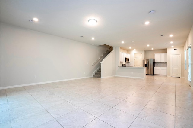 unfurnished living room with light tile patterned floors