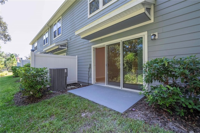 exterior space with central AC unit and a yard