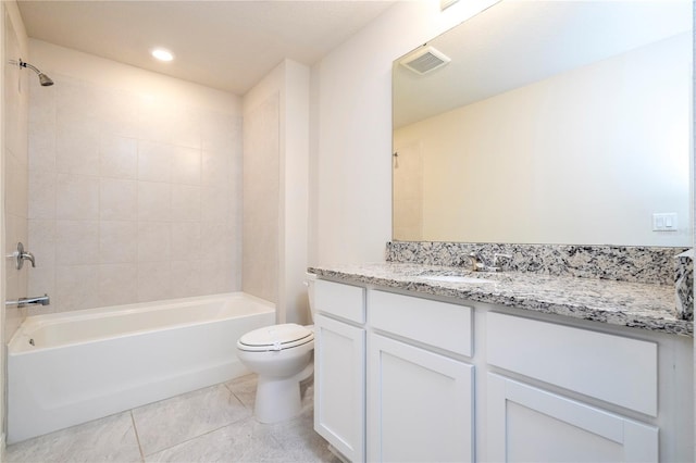 full bathroom featuring tiled shower / bath, vanity, toilet, and tile patterned floors