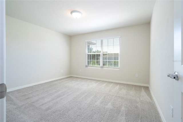 spare room with light colored carpet