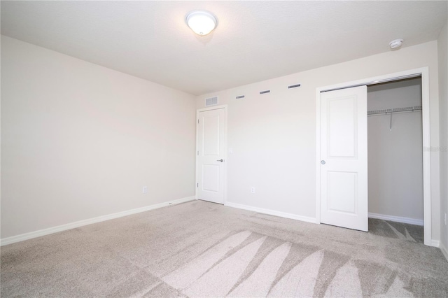 unfurnished bedroom featuring a closet and carpet flooring