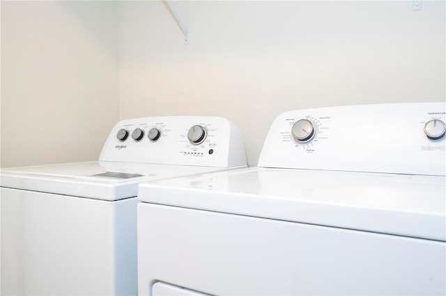 clothes washing area featuring independent washer and dryer