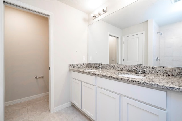 bathroom featuring tile patterned floors, vanity, and tiled shower