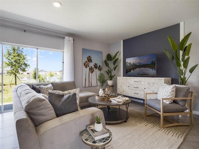 tiled living room featuring a healthy amount of sunlight