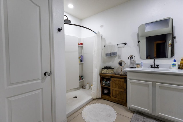 bathroom featuring walk in shower, tile patterned flooring, and vanity