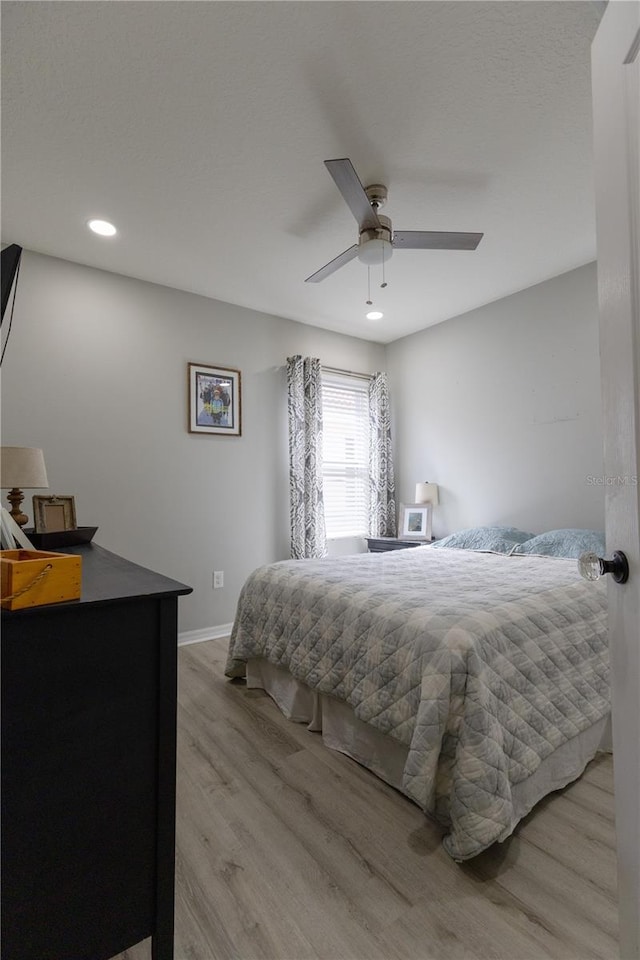 bedroom featuring recessed lighting, wood finished floors, baseboards, and ceiling fan