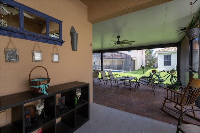 view of patio featuring a lanai and a ceiling fan