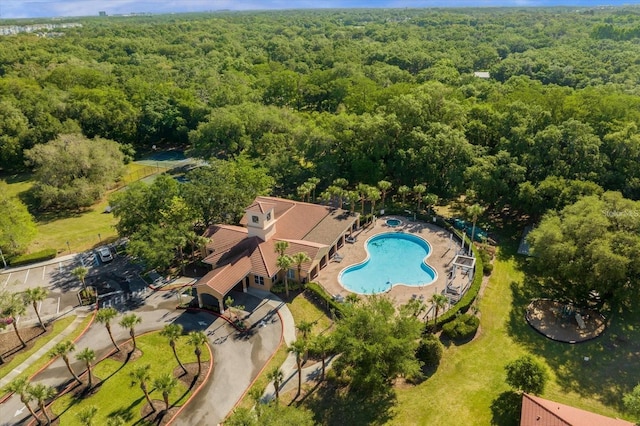 drone / aerial view featuring a wooded view