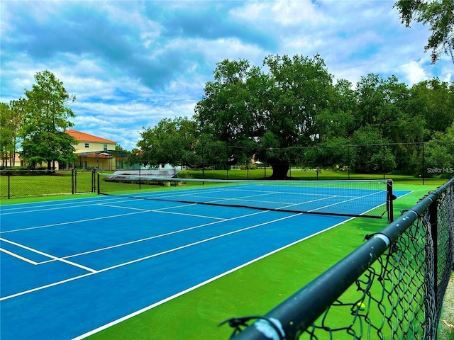 view of tennis court with fence