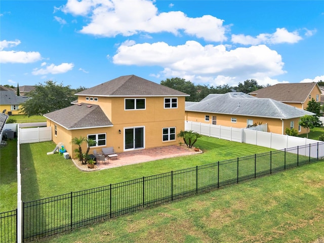 rear view of house with a patio area, a fenced backyard, a lawn, and stucco siding