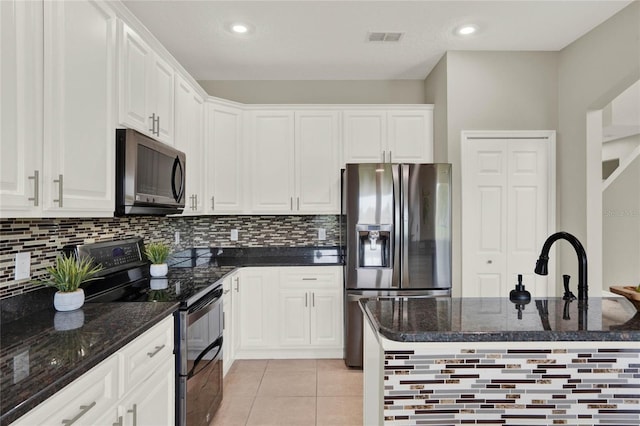 kitchen with light tile patterned floors, visible vents, white cabinetry, dark stone counters, and black appliances