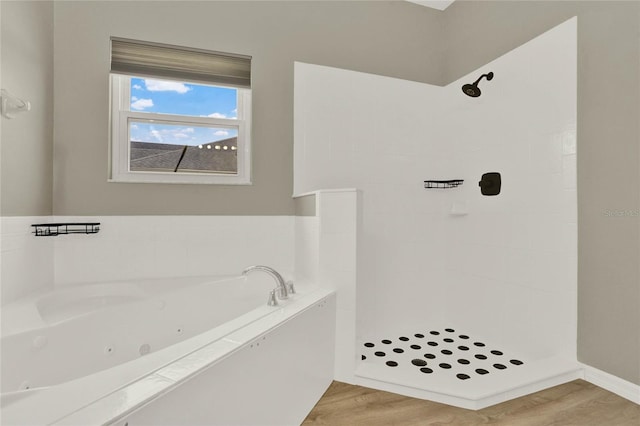 full bath featuring a shower, a tub with jets, and wood finished floors