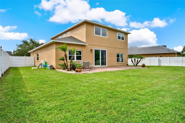 rear view of property with a yard, a patio, a fenced backyard, and stucco siding