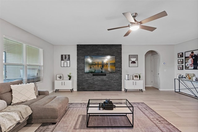 living room with light hardwood / wood-style flooring and ceiling fan