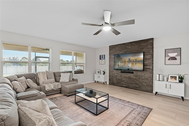 living room featuring light wood-type flooring and ceiling fan