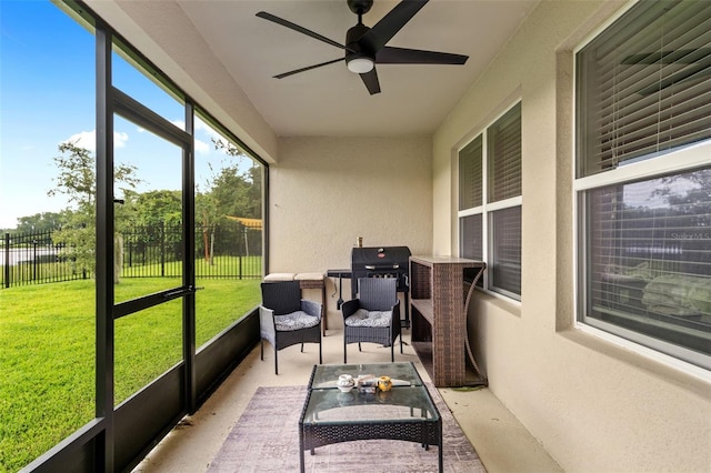 sunroom featuring ceiling fan