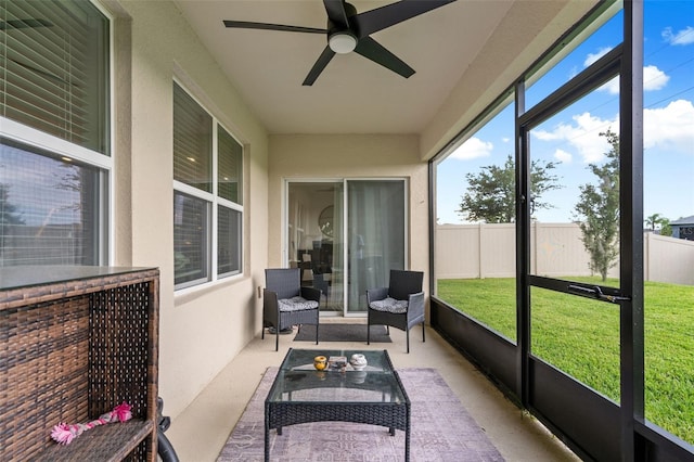 sunroom featuring ceiling fan