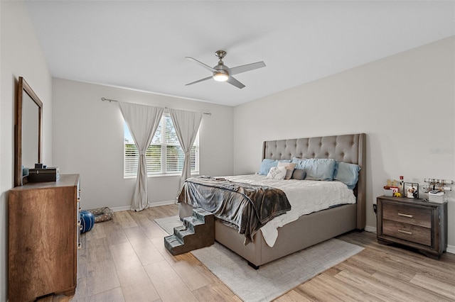 bedroom with light hardwood / wood-style floors and ceiling fan