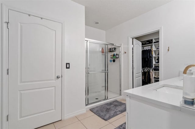 bathroom with vanity, tile patterned floors, and an enclosed shower