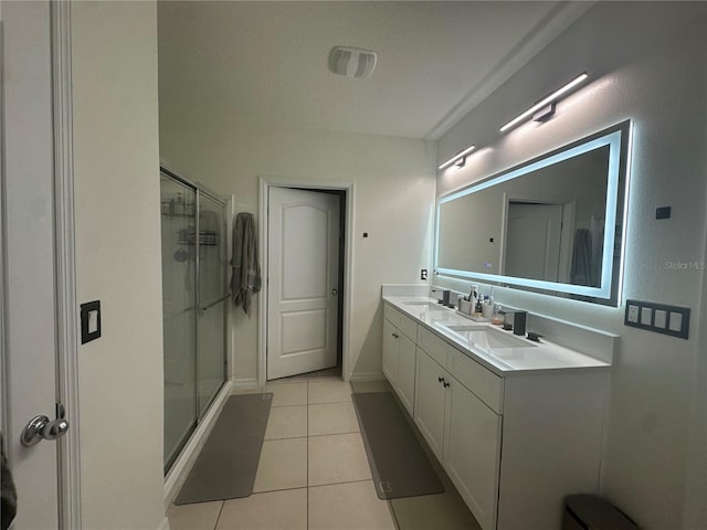 bathroom featuring vanity, a textured ceiling, tile patterned flooring, and an enclosed shower