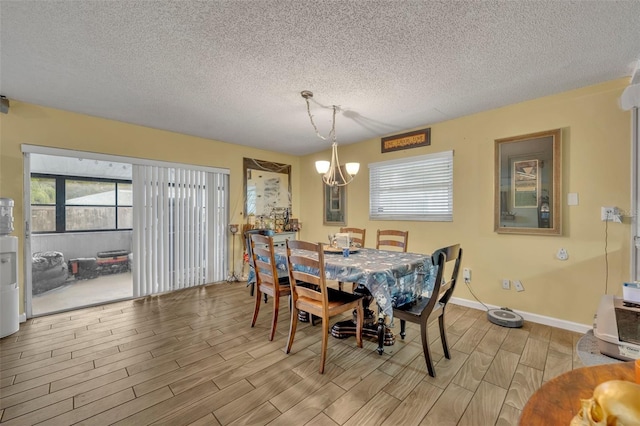 dining room featuring a chandelier, light hardwood / wood-style flooring, and a textured ceiling