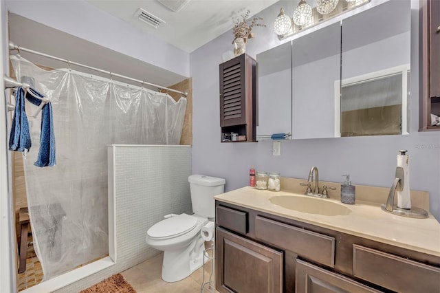 bathroom featuring a shower with curtain, vanity, toilet, and tile patterned floors