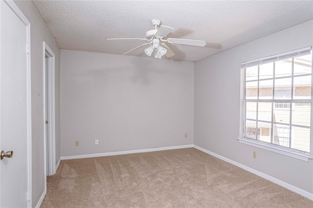 carpeted spare room with ceiling fan and a textured ceiling