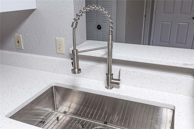 interior details with light stone counters and sink