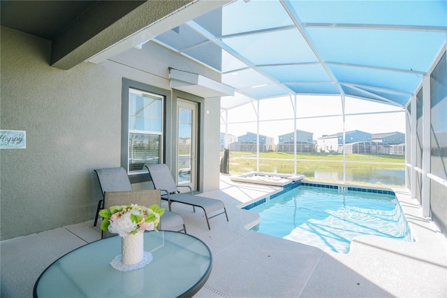 view of swimming pool with a lanai, a patio, and a water view