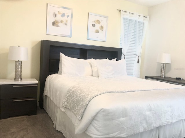 bedroom with dark colored carpet