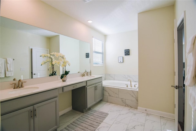 bathroom featuring vanity and tiled bath