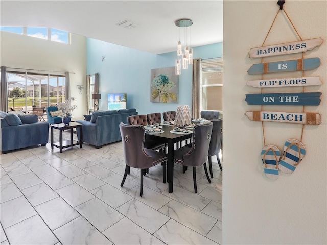8938 Cabot Cliffs Dr, Davenport, FL 33896 - dining room featuring marble look tile flooring and a chandelier