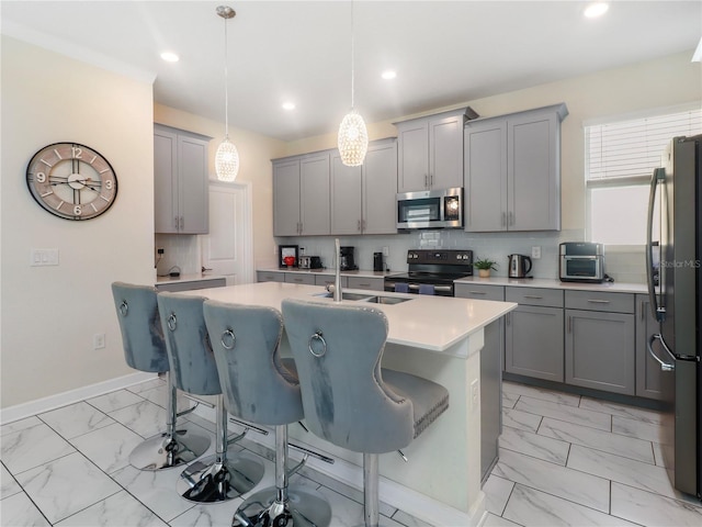 8938 Cabot Cliffs Dr, Davenport, FL 33896 - kitchen with stainless steel appliances, gray cabinetry, light marble finish flooring, a center island with sink, and recessed lighting