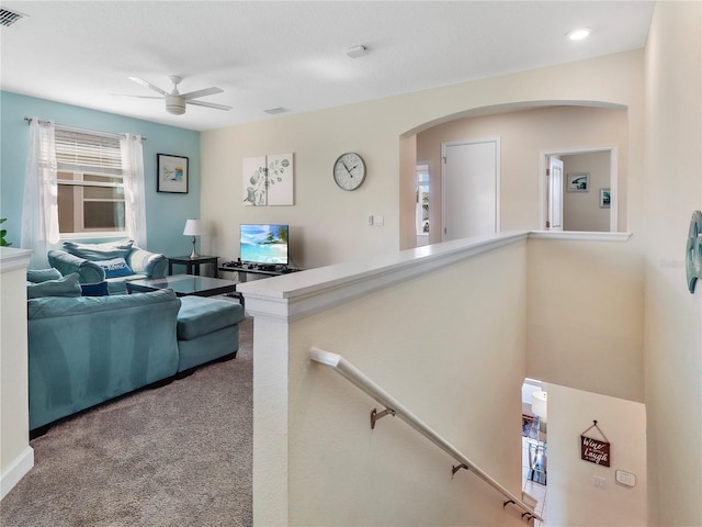 8938 Cabot Cliffs Dr, Davenport, FL 33896 - living room with ceiling fan, carpet flooring, and arched walkways