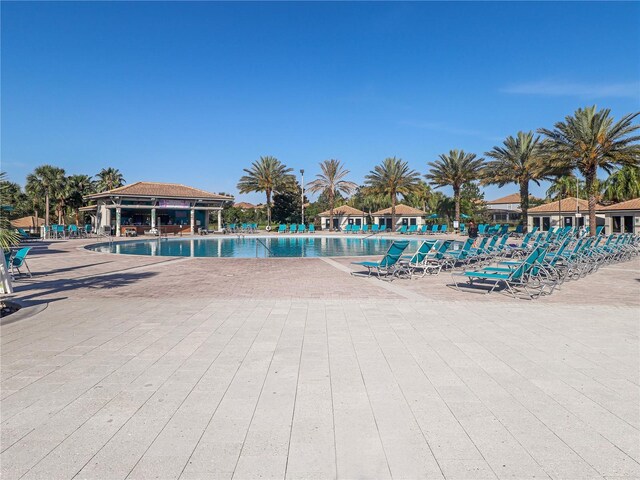 8938 Cabot Cliffs Dr, Davenport, FL 33896 - community pool with a patio area