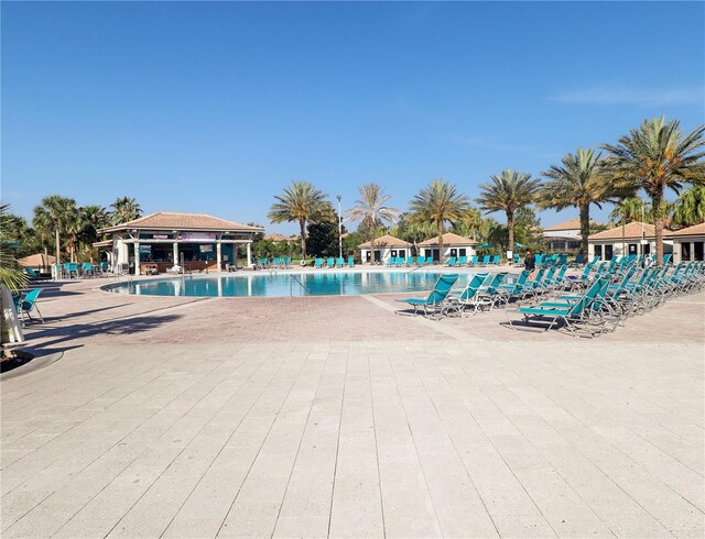 8938 Cabot Cliffs Dr, Davenport, FL 33896 - community pool featuring a patio area