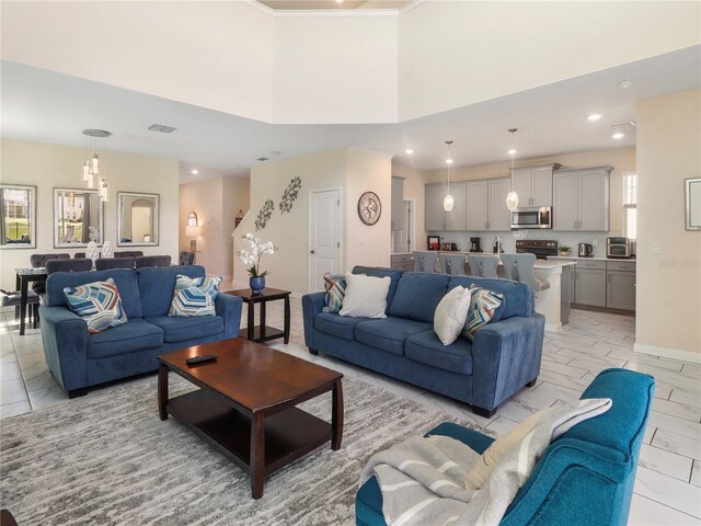 8938 Cabot Cliffs Dr, Davenport, FL 33896 - living area with recessed lighting, light marble finish floors, and a towering ceiling