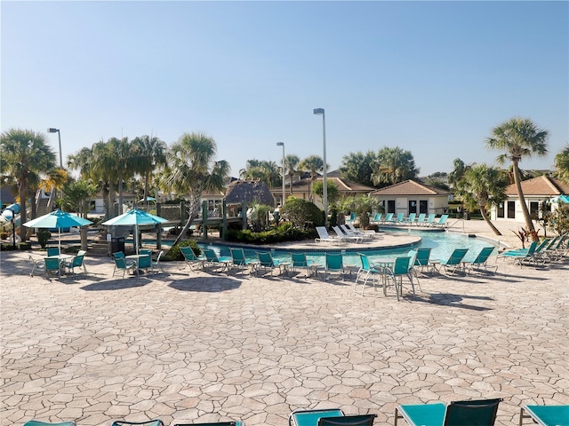 8938 Cabot Cliffs Dr, Davenport, FL 33896 - community pool featuring a patio area
