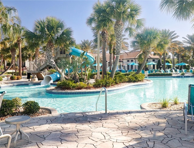 8938 Cabot Cliffs Dr, Davenport, FL 33896 - community pool featuring a water slide and a patio