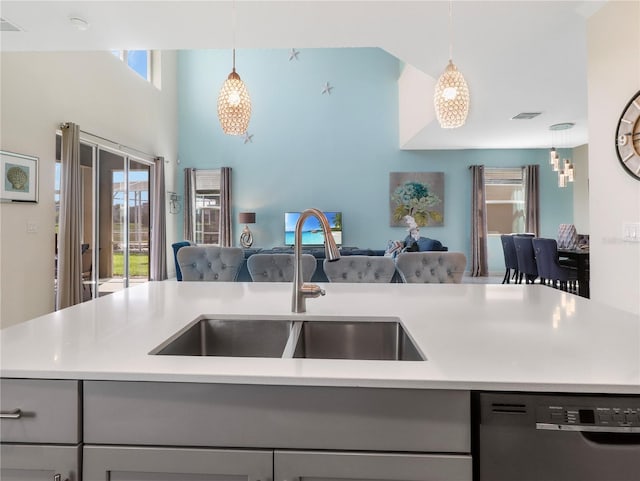 8938 Cabot Cliffs Dr, Davenport, FL 33896 - kitchen with open floor plan, a sink, gray cabinetry, black dishwasher, and light countertops