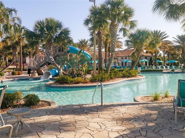 8938 Cabot Cliffs Dr, Davenport, FL 33896 - community pool featuring a water slide and a patio