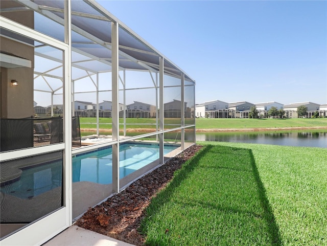 8938 Cabot Cliffs Dr, Davenport, FL 33896 - outdoor pool with a lawn, a water view, glass enclosure, and a residential view
