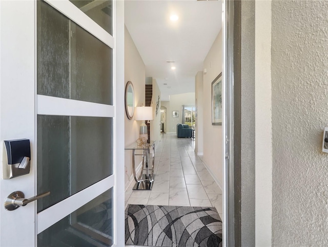 8938 Cabot Cliffs Dr, Davenport, FL 33896 - hallway featuring light marble finish floors