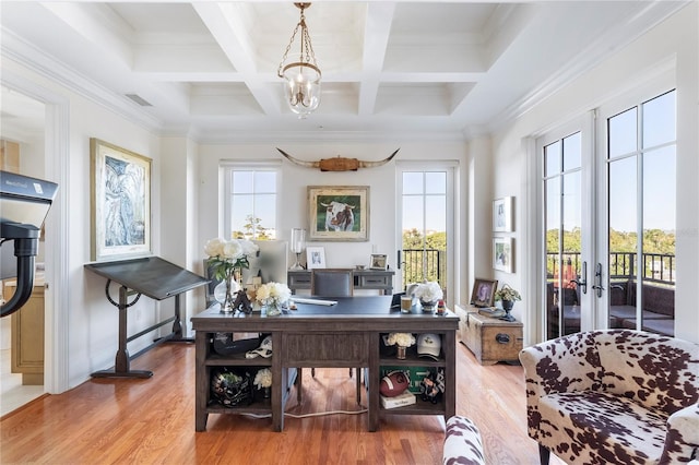 office space featuring coffered ceiling, beamed ceiling, plenty of natural light, and light hardwood / wood-style floors