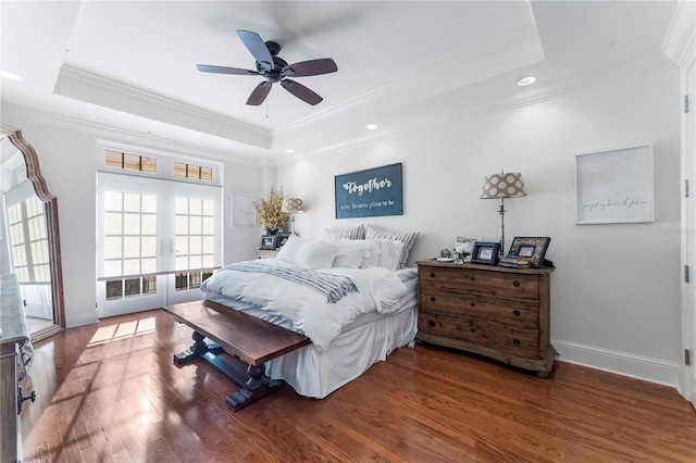 bedroom featuring dark hardwood / wood-style flooring, a raised ceiling, crown molding, ceiling fan, and french doors